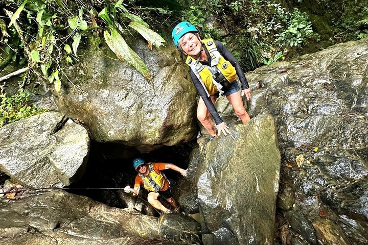 Lush green rainforest trail with waterfall in El Yunque
